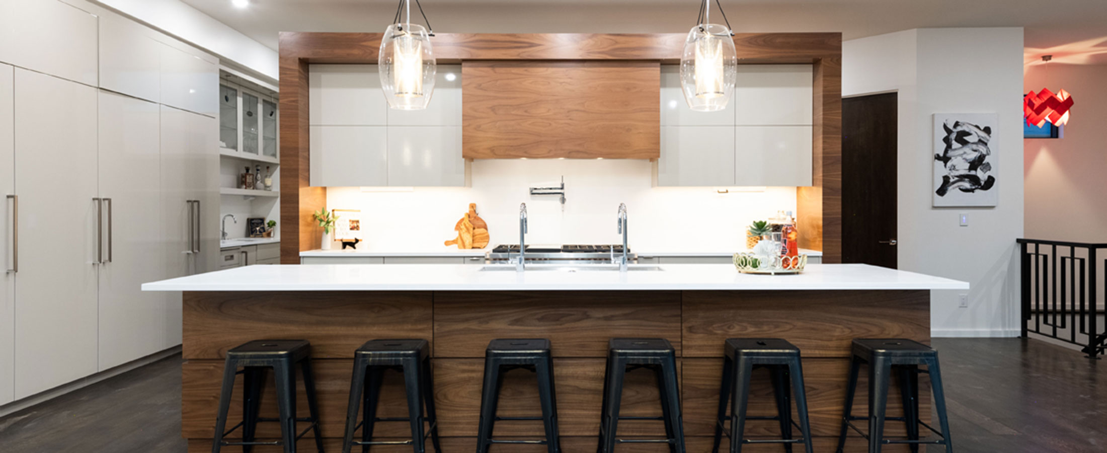 kitchen with bar stools and glass pendant lights